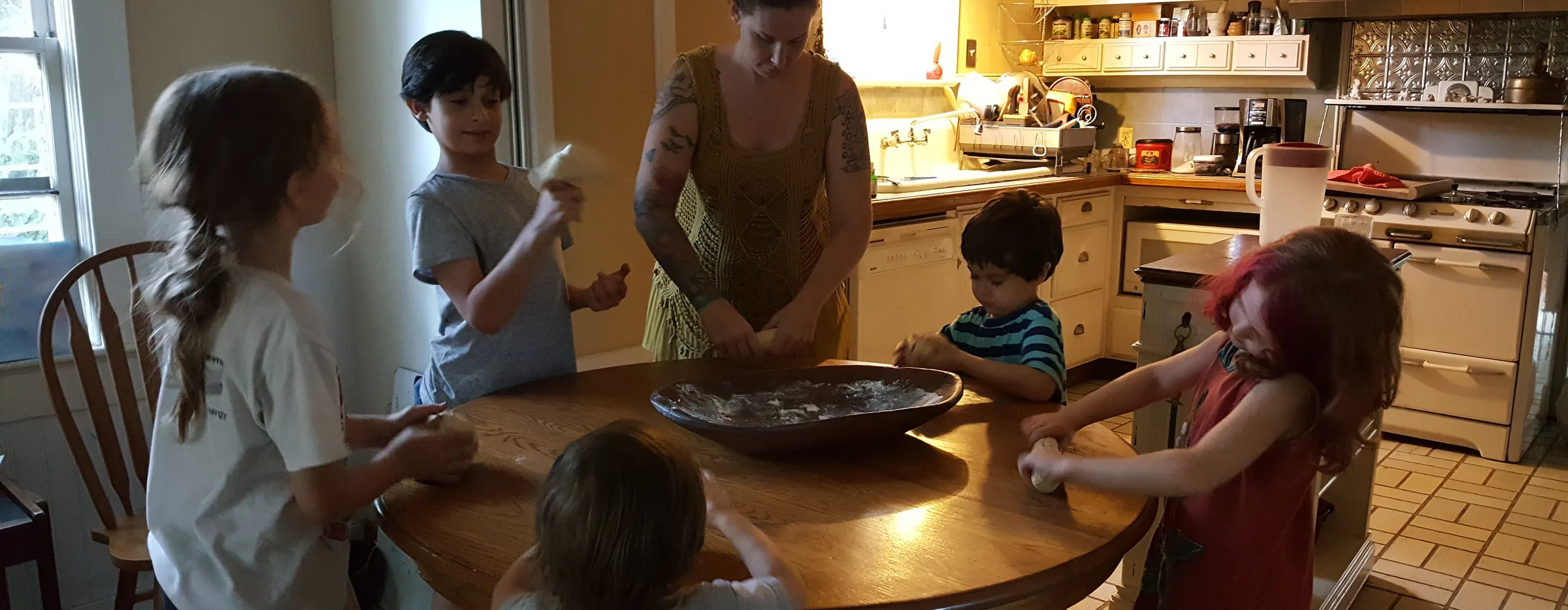 Children and a parent busy together in the kitchen