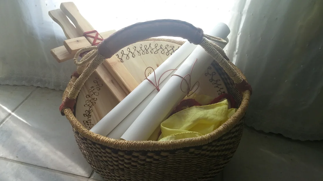 A basket holding a lyre, rolled papers and a silk